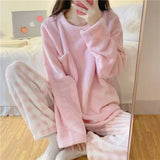 Women's pink fleece pyjamas set with solid top and plaid pants - warm winter sleepwear from IkoChic.