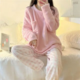 Women's pink fleece pyjamas set with solid top and plaid pants - warm winter sleepwear from IkoChic.